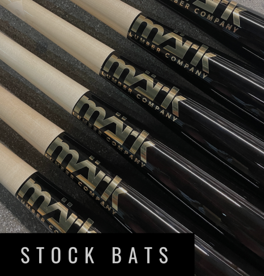 Close-up of MÄRK Lumber stock baseball bats with black finish and maple handles, showcasing the bold MÄRK logo for immediate purchase and use.